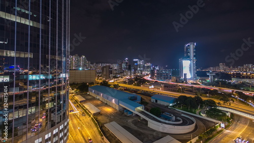 Top view of busy traffic night in finance urban timelapse hyperlapse with panorama of city buildings, hong kong city