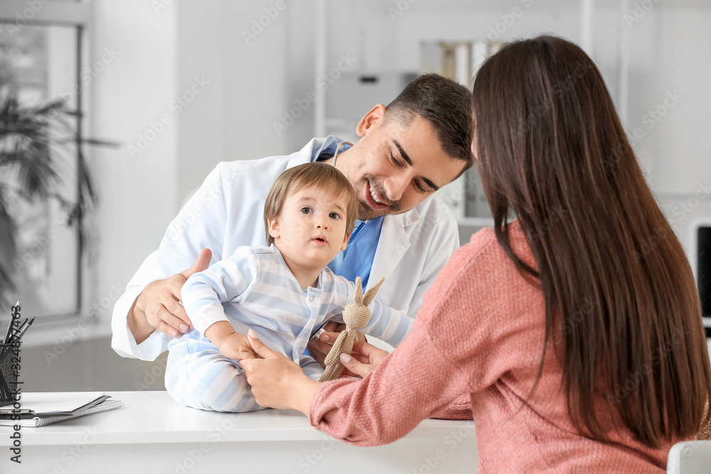 Woman with little baby visiting pediatrician in clinic Woman with little baby visiting pediatrician in clinic
