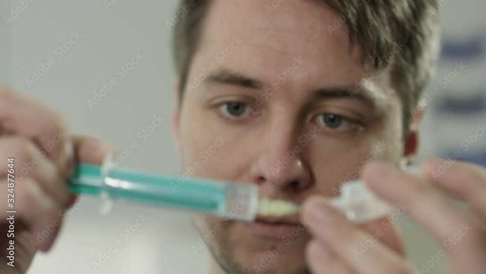 YoungDoctor preparing syringe in hospital YoungDoctor preparing syringe in hospital