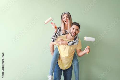 Young couple with paint rol...