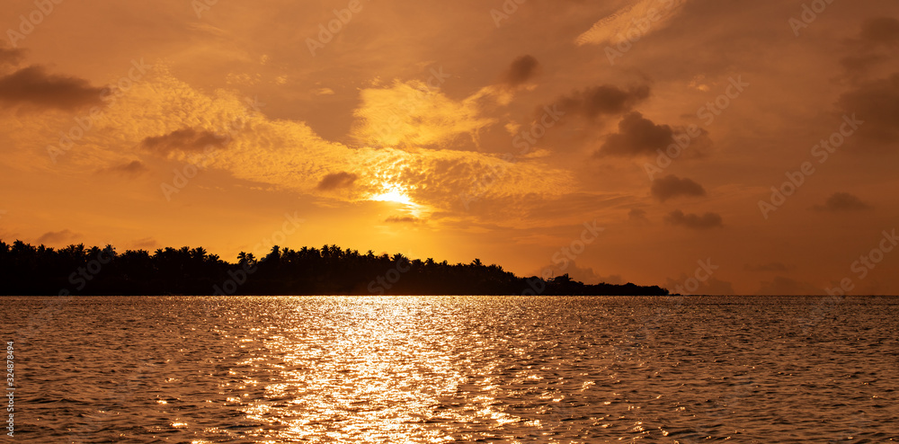 dramatic sunset sky on a tropical island silhouette in indian ocean dramatic sunset sky on a tropical island silhouette in indian ocean