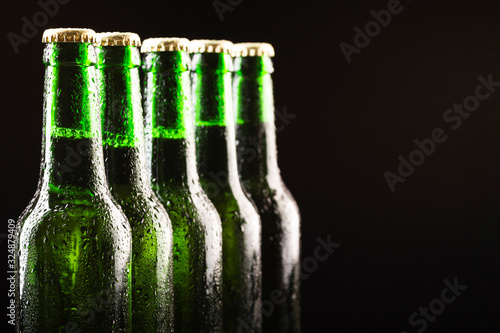 Glass bottles of cold beer are arranged