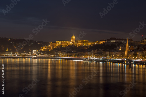 Danube river and illuminated historic boildings at night in Budapest, Hungary