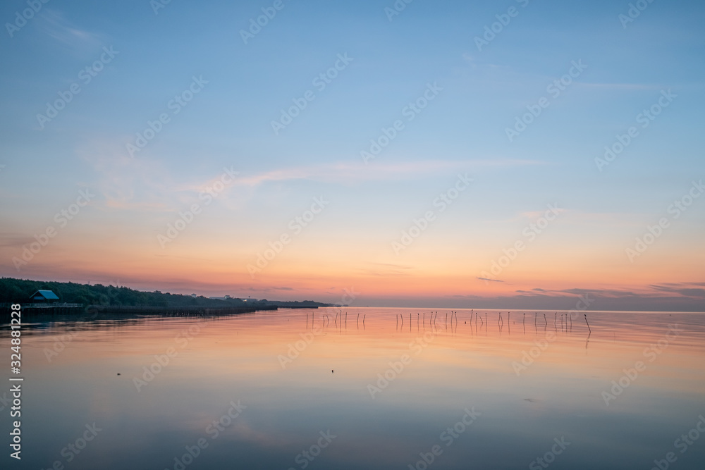 Fototapeta premium On the coast of the Gulf of Thailand With seagulls flying out to find food on the beach in the morning