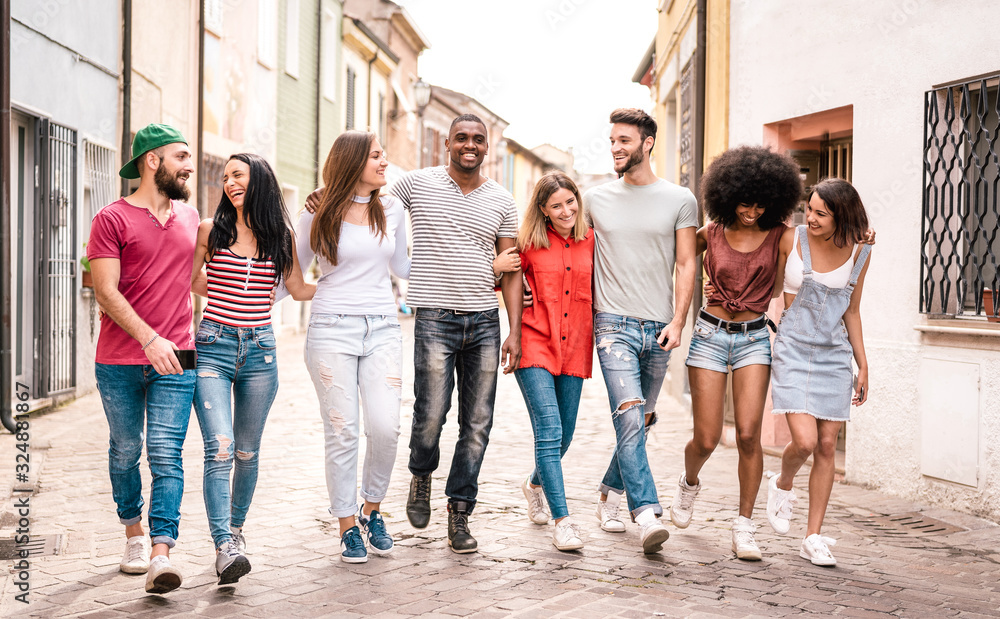 Multiracial millennial friends walking in city center - Happy guys and girls having fun around old town streets - University students on travel vacations  - Warm desaturated filter