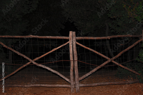 Wooden gate, illuminated in the night.