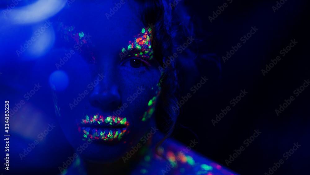 Close-up view of woman with fluorescent make-up