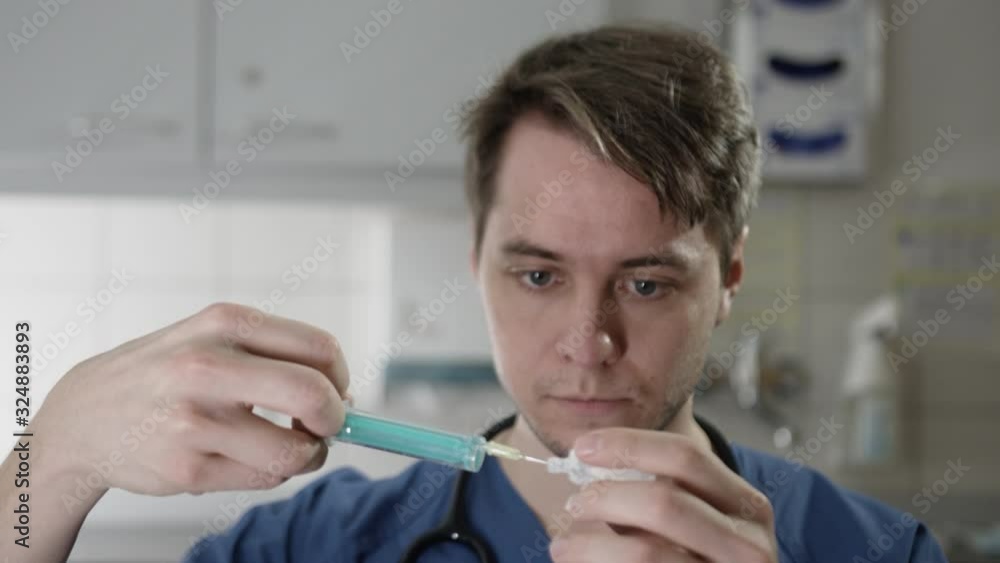 Young Doctor preparing syringe Young Doctor preparing syringe