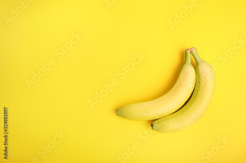 Ripe bananas on yellow background.
