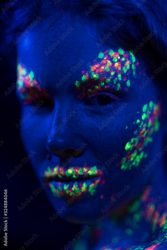 Close-up view of woman with fluorescent make-up