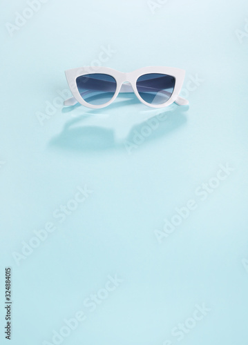 White sunglasses on blue background