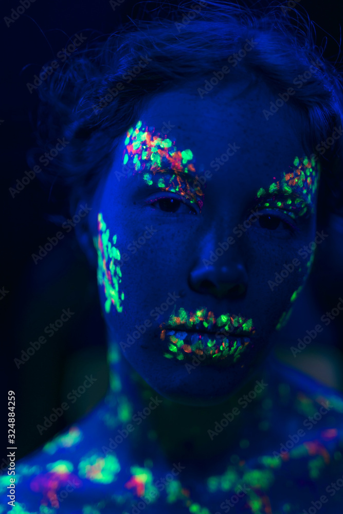 Close-up view of woman with fluorescent make-up