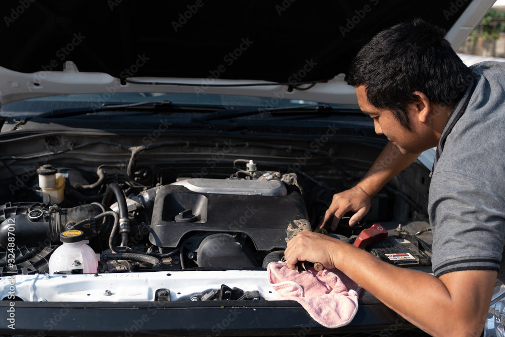 The driver is checking the car before traveling, safety first concept The driver is checking the car before traveling, safety first concept