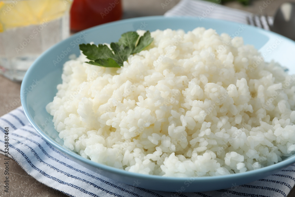 Composition with delicious rice on grey background, close up Composition with delicious rice on grey background, close up