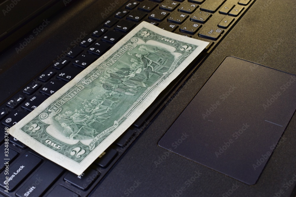 Dollar and ruble bills on a black keyboard Dollar and ruble bills on a black keyboard