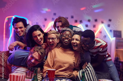 Portrait of multiethnic group of young people laughing and having fun together at the party