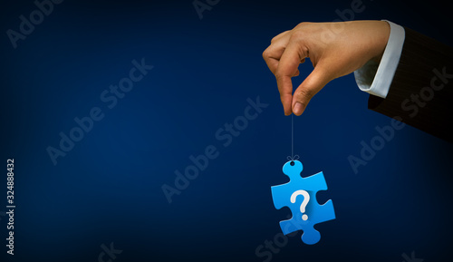 hand holding question mark with puzzle sign