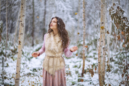 girl walks in a winter forest © AKaltykova