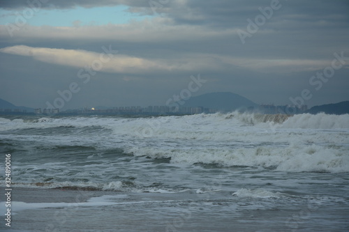 Wave after wave come crushing on the beach at Haitang Bay on Hainan island photo