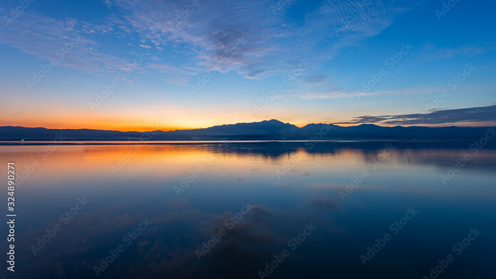 Sunset sky over mountain and lake with the reflection Sunset sky over mountain and lake with the reflection