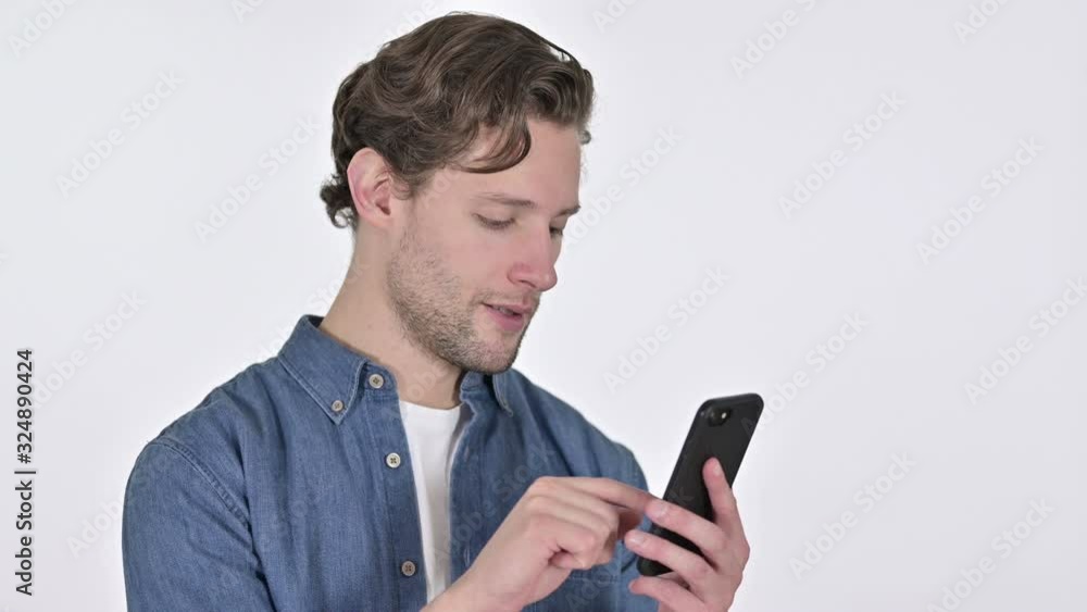 Portrait of Focused Young Man using Smartphone on White Background Portrait of Focused Young Man using Smartphone on White Background