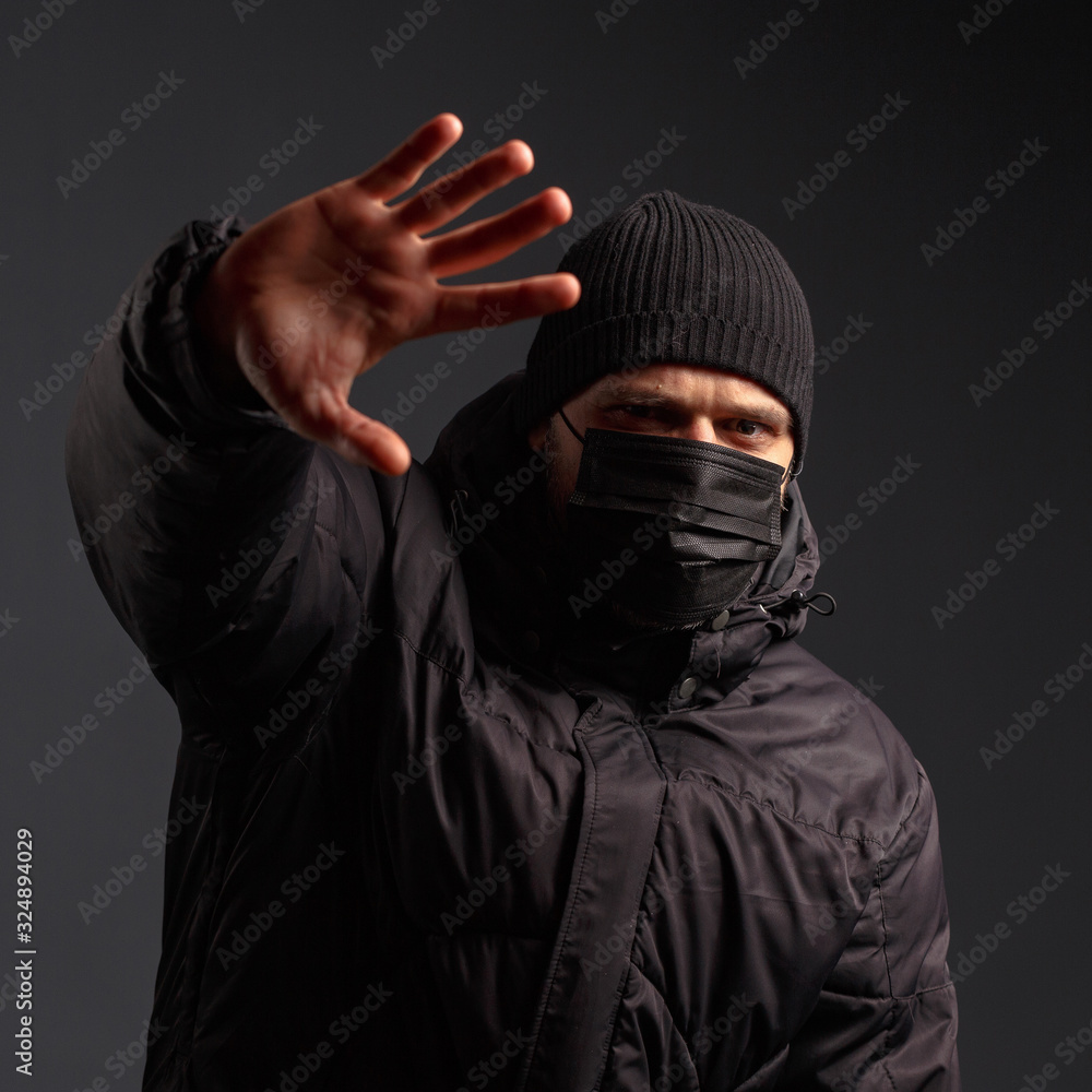 portrait of a young man in a jacket and an antivirus mask portrait of a young man in a jacket and an antivirus mask