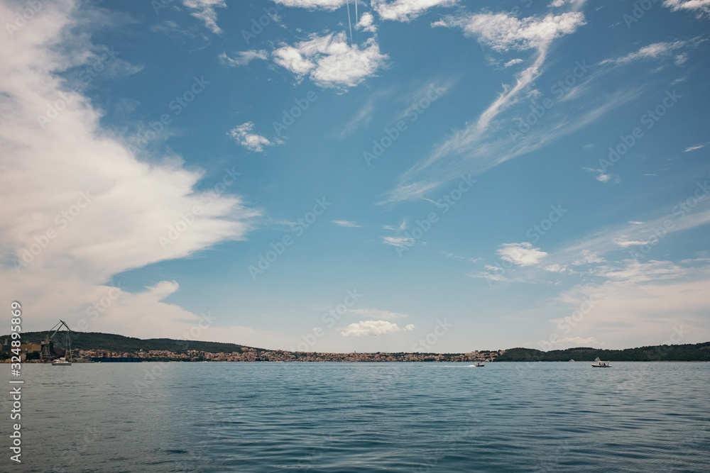 Wide view of a lake, clouds and mountains in the background