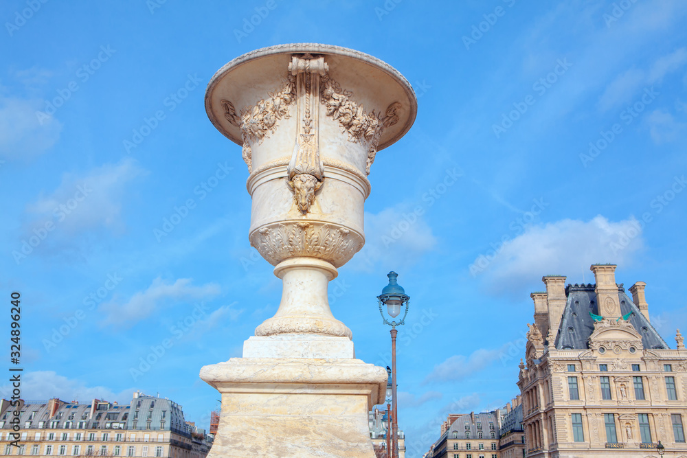 white stone flower pot on parisian street 