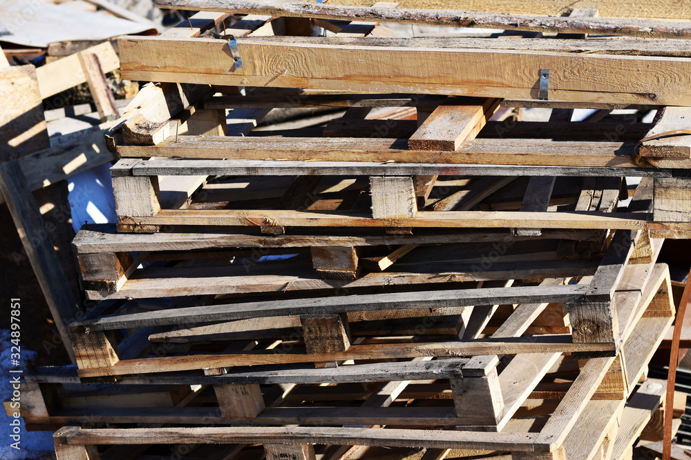 wooden pallets are stacked carelessly on the street. wooden pallets are stacked carelessly on the street.