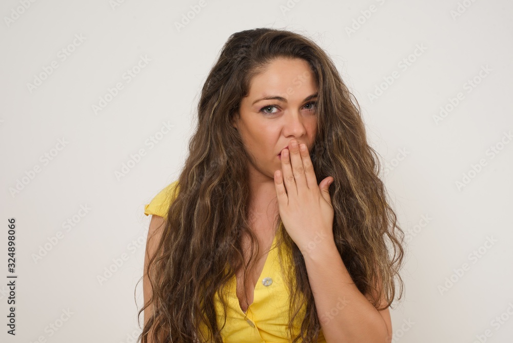 Oh! I think I said it! Close up portrait of lady in white, street style t-shirt cover open mouth by hand palm, look at camera with big eyes isolated on bright mint background. Oh! I think I said it! Close up portrait of lady in white, street style t-shirt cover open mouth by hand palm, look at camera with big eyes isolated on bright mint background.