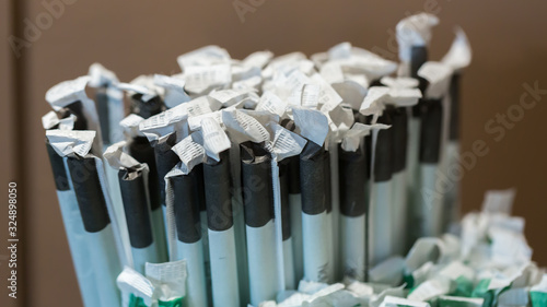 Vienna  Austria - Jan 30  2020  Close up of drinking straws wrapped in paper. Black and white color. Used for hot  e. g. latte macchiato  and cold drinks  e. g. lemonade . Panorama format. At a Caf  .