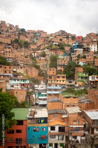 Medellin, Antioquia /Colombia - January 20 2020: Red Bricks Houses, A few Painted in Colors Built in the Steep Hills of the Valley