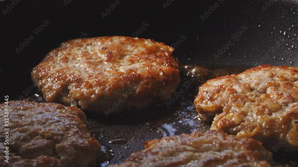 Cooking hamburger. Beef or pork cutlet grilling on pan. Cooking hamburger. Beef or pork cutlet grilling on pan.