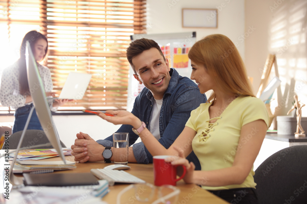 Professional designers working together in modern office Professional designers working together in modern office