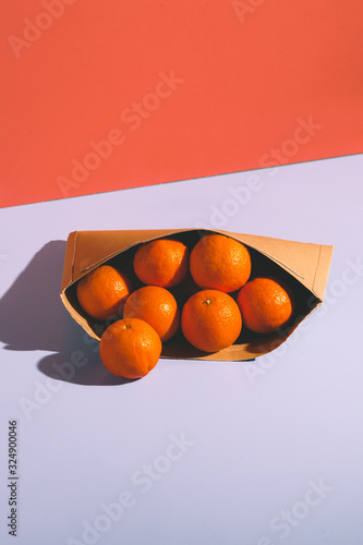 Oranges in a Container on Red and Blue Background