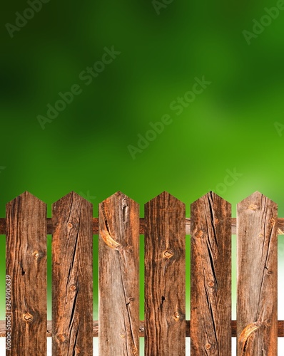 Brown old cracked fence on garden greenery background. Summer abstract illustration.