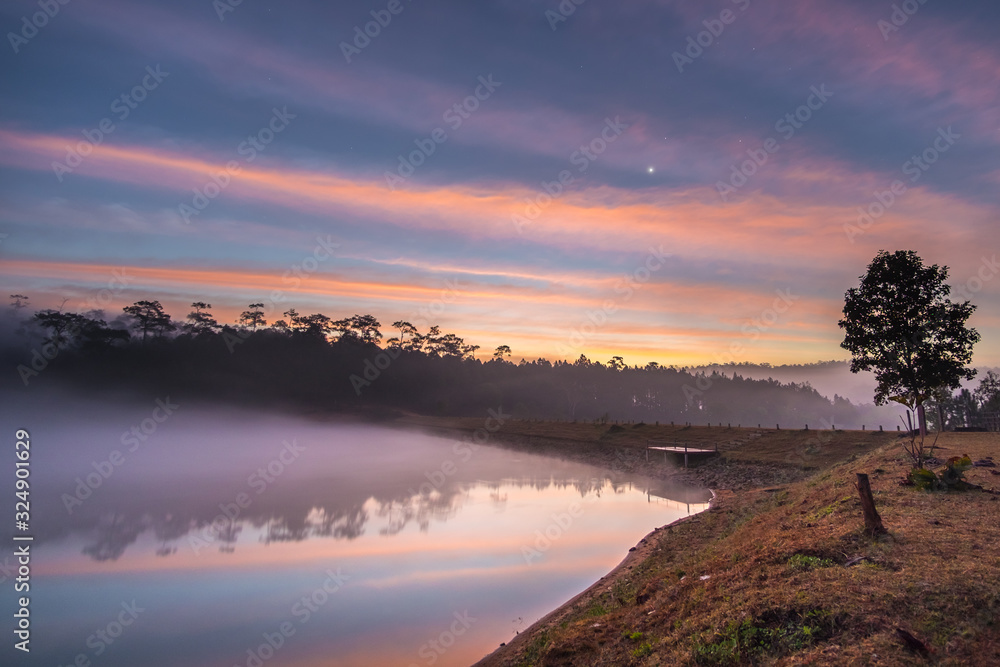 Foggy reservoir of Watchan Royal Project with beautiful early morning sky (Kalayaniwattana district, Chiang Mai, Thailand)