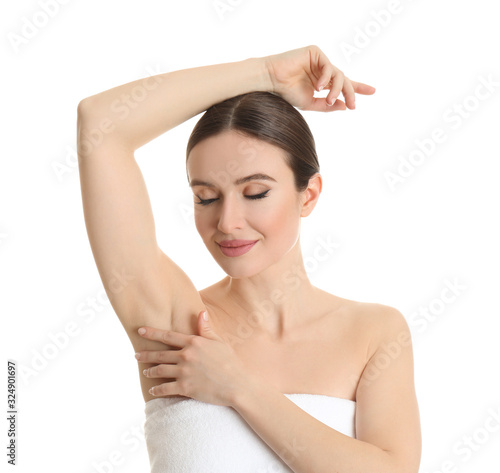 Young beautiful woman showing armpit with smooth clean skin on white background