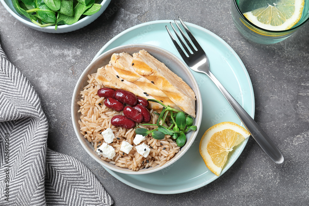 Tasty rice with beans served on grey table, flat lay Tasty rice with beans served on grey table, flat lay