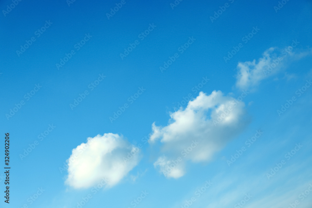 Beautiful light blue sky with fluffy clouds