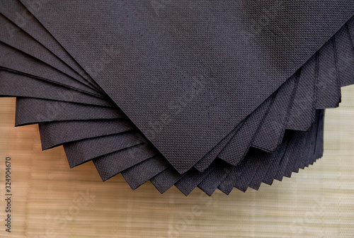 black napkins with wooden background