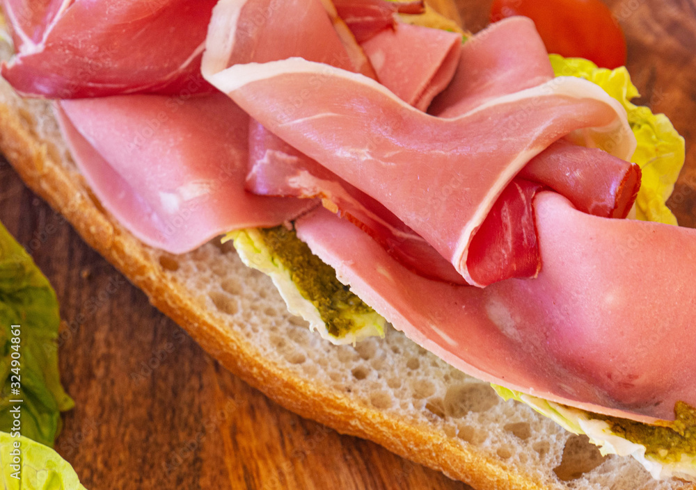 Tasty and healthy sandwich with ham and cheese and herbs Tasty and healthy sandwich with ham and cheese and herbs