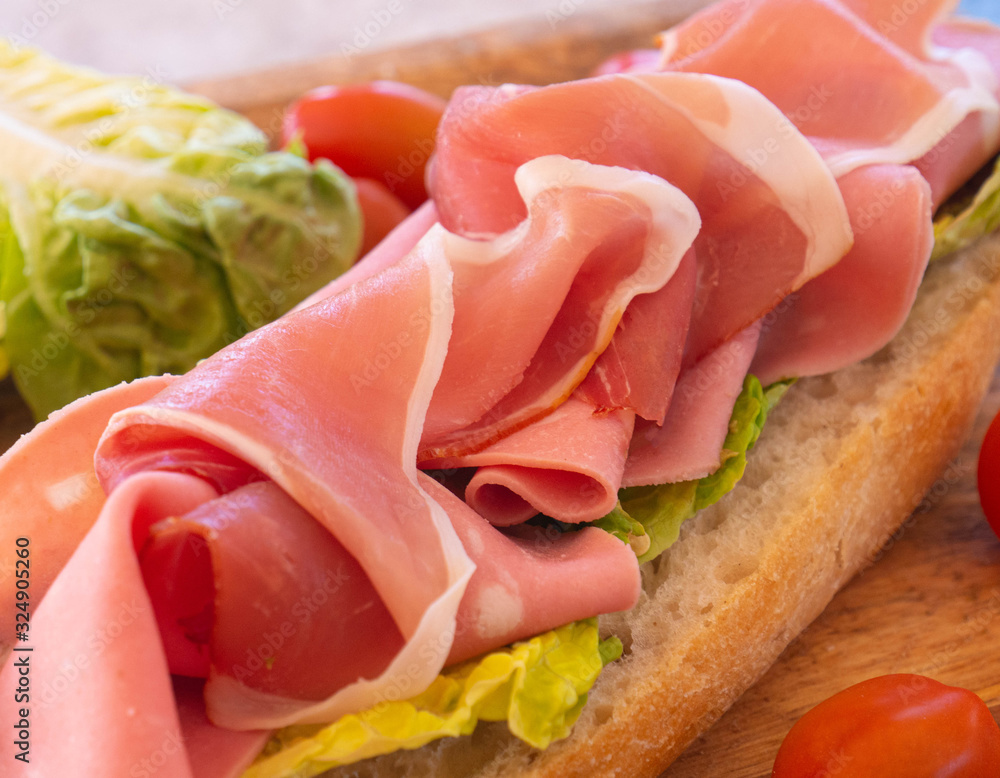 Tasty and healthy sandwich with ham and cheese and herbs