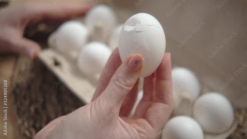Broken egg in a female hand. Eggshell crack. Close up. Broken egg in a female hand. Eggshell crack. Close up.