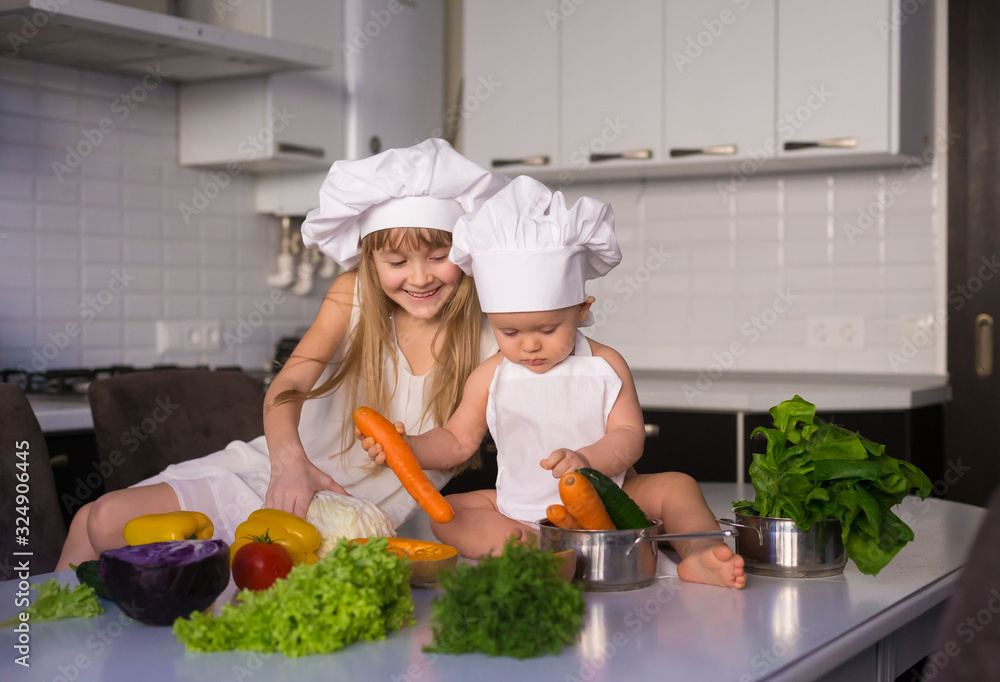 little girl and boy, white chef hat, vegetables little girl and boy, white chef hat, vegetables
