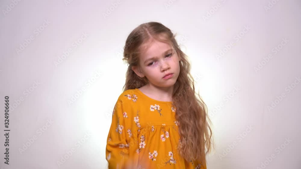 Headache little girl with blond hair, yellow dress Headache little girl with blond hair, yellow dress