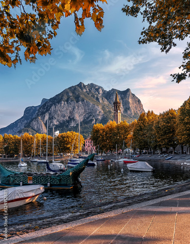 Incredible evening scene in Lecco town on Como lake, during sunset. Amazing colorful cityscape under bright sunlight. Best popular placec for travel. wonderful Autumn nature scenery. Beauty in world. photo