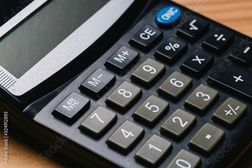 Modern calculator, Business and Finance accounting concept on wooden table