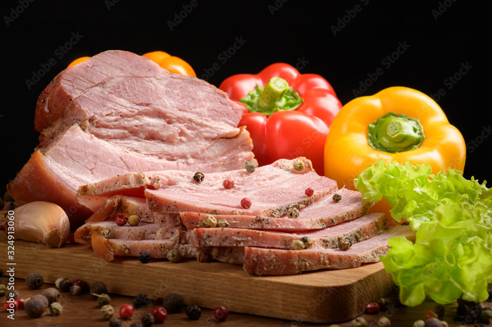 Smoked meat sliced on a wooden table with the addition of fresh herbs, aromatic spices and paprika. A natural product from an organic farm produced using traditional methods. Smoked meat sliced on a wooden table with the addition of fresh herbs, aromatic spices and paprika. A natural product from an organic farm produced using traditional methods.