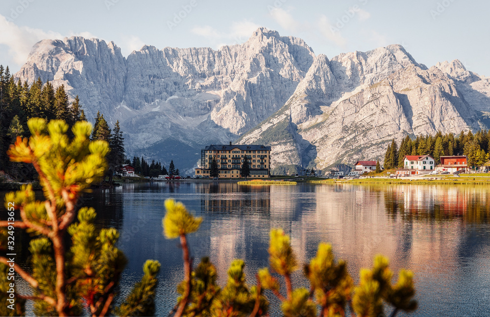 Wonderful Autumn Landscape. Great view on Misurina Lake with the Punta Sorapis mountain of Dolomites in the background, in sunny day. National Park Tre Cime di Lavaredo, Auronzo, South Tyrol, Italy,